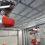 Infraestructura de ventilación y aspiración industrial diseñada para robots en procesos de manufactura.