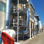 Sistema de filtración industrial que incluye un filtro de mangas y ventilador centrífugo conectado por conductos metálicos